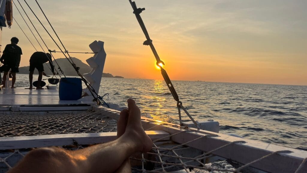 Sunset view from a boat trip in Labuan Bajo, Flores Indonesia with golden light over the ocean