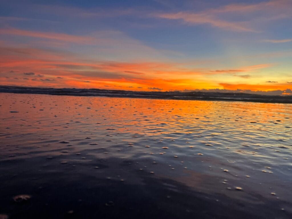 Colorful sunset over the ocean seen from Canggu Beach in Bali