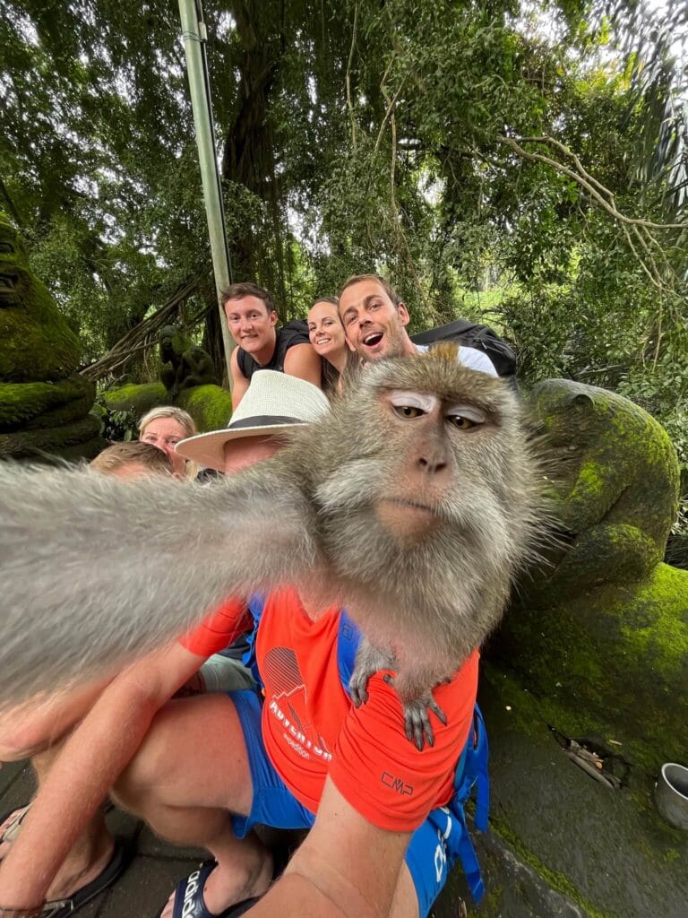 Monkey takes a selfie with tourists at Ubud Monkey Forest, Bali
